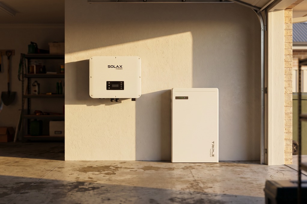 SolaX inverter and Triple Power battery together in a garage, in warm afternoon light