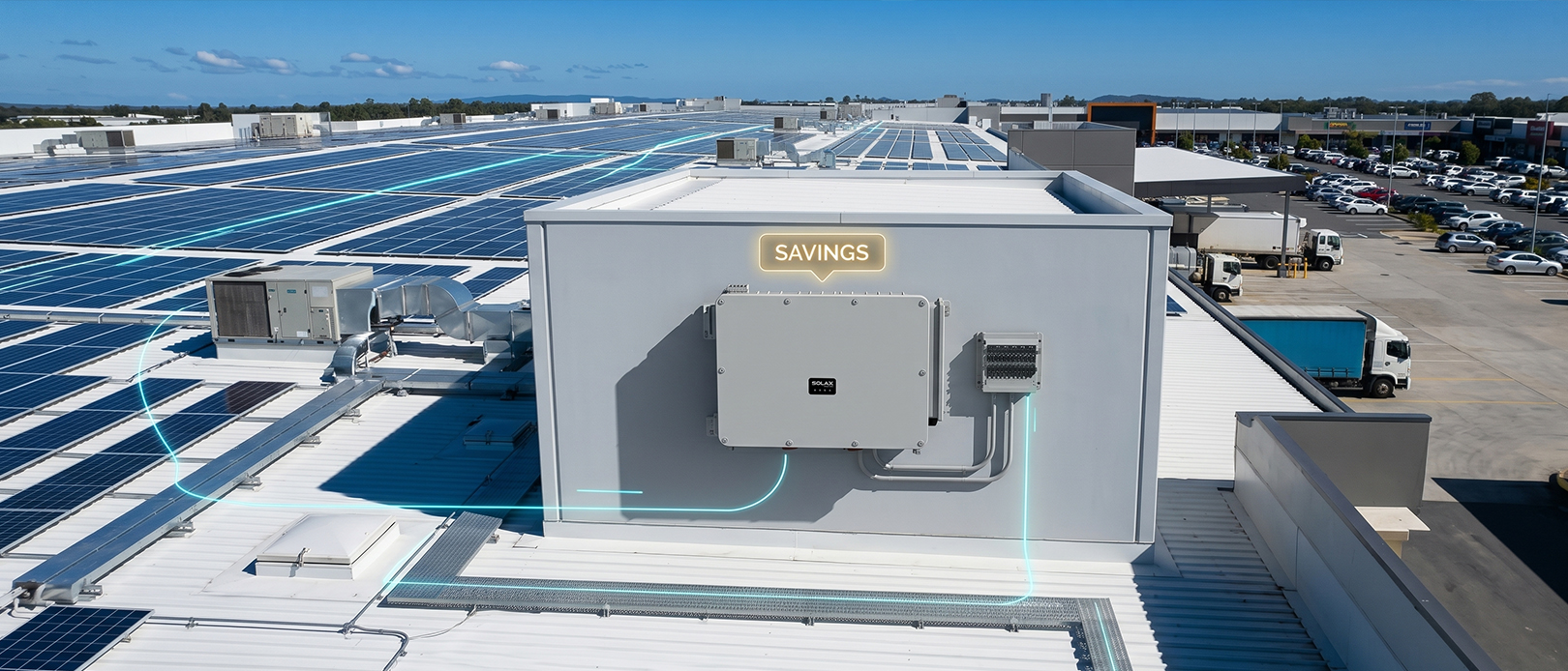 SolaX commercial string inverter mounted on Queensland retail centre wall with demand-charge HUD overlay