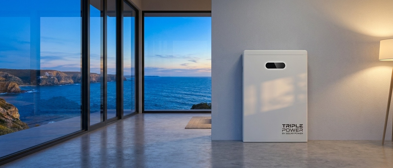 Triple Power by SolaX Power home battery standing on a polished concrete floor in a modern interior with a dramatic coastal cliff view at dusk.